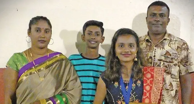 Ria Dipashna Devi (front) with her mother Ashika Mistry, brother Vignesh Mistry and father Vinesh Mistry after receiving her award.
