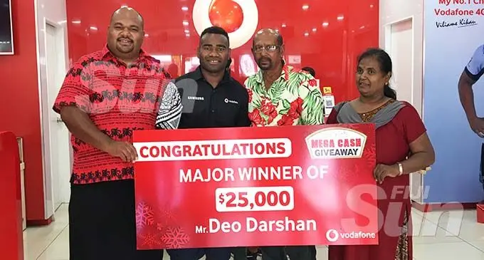 From left; Vodafone Fiji sponsorship manager Adriu Vakarau, Fijian 7s player Jerry Tuwai, major prize winner Deo Darshan and his wife Prabha Wati at the Vodafone outlet in Nakasi on December 24, 2019. Photo: Renu Radhika