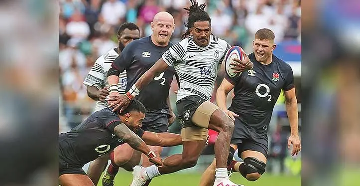 Flying Fijian winger Selestino Ravutaumada runs away from Manu Tuilagi’s tackle against England in Twickenham on August 26, 2023. Fiji won 30-22. Photo: AFP