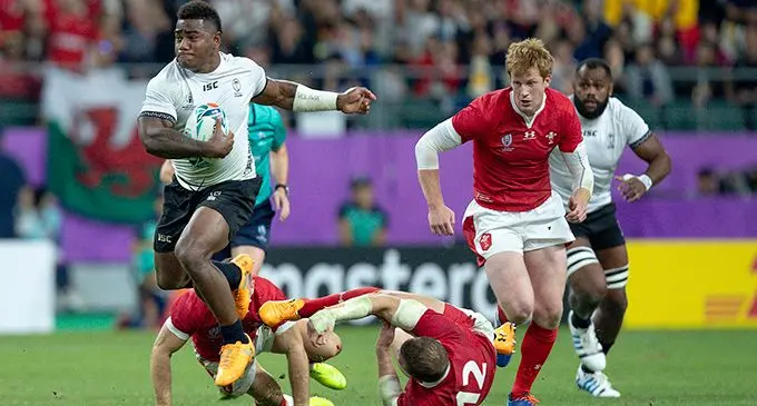 Josua Tuisova bursts through a Wales defence line during their Pool D Rugby World Cup match at the Oita Stadium in Japan, on October 9, 2019. Tuisova scored a try against the Welsh but Fiji fell short with a 17-29 loss.   Photo: Bruce Southwick/ZoomFiji