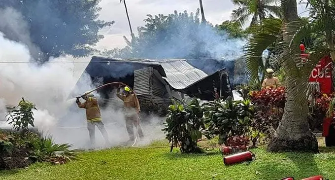 Fire officers trying to save a property on Taveuni Island on March 22, 2022. Photo: Supplied.