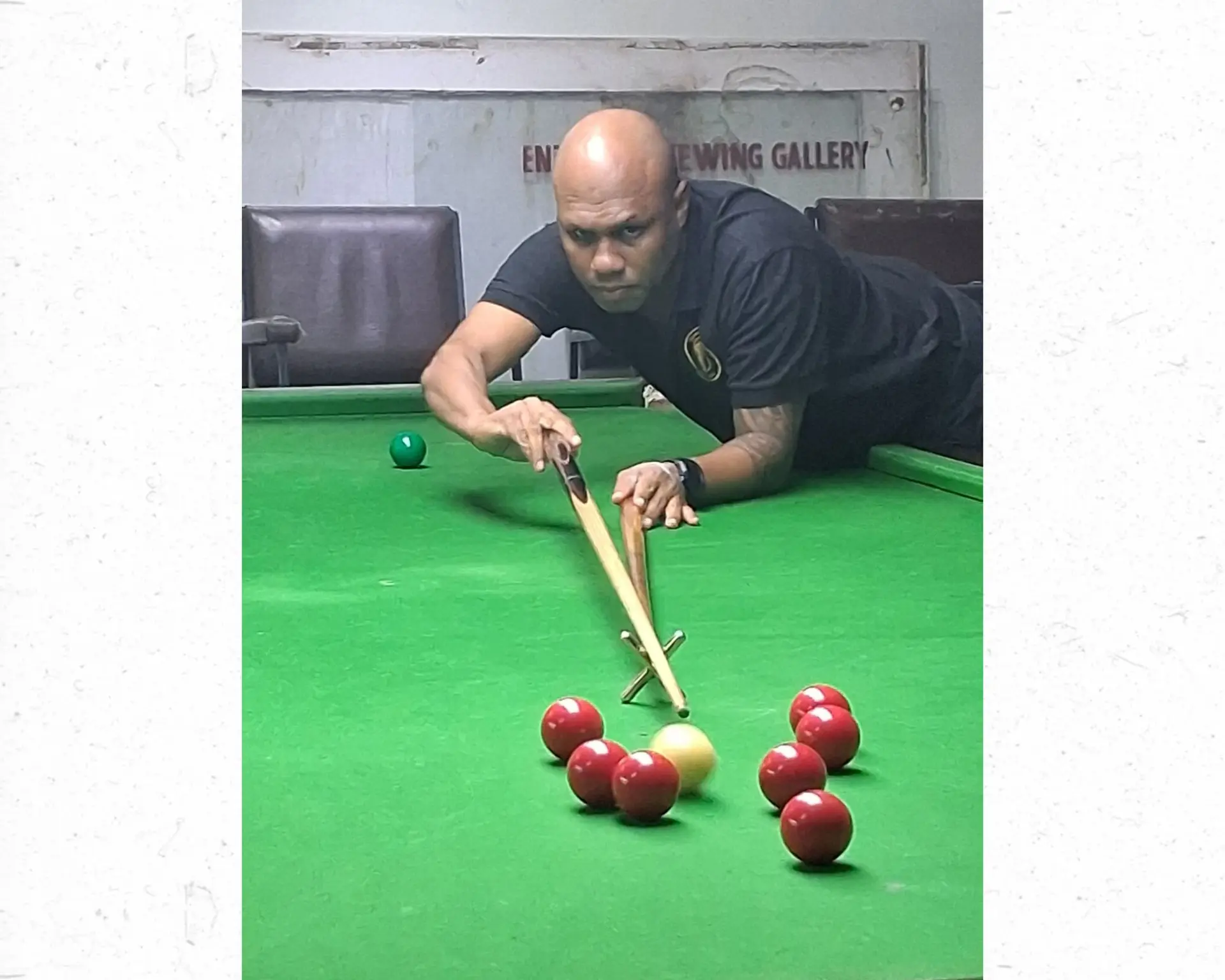 Esala Talebula lines up a shot during a snooker match.