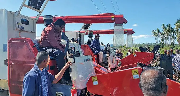 Minister for Agriculture, Mahendra Reddy, tries out the new rice harvester in Dreketi, Macuata, on June 9, 2022. Photo: Ministry of Agriculture