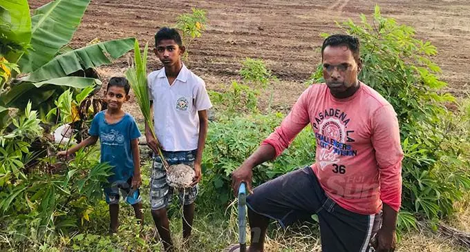 Mukesh with his sons Rachit William Bennion (middle), and Monish William Bennion, at their plantation which is next to the development site of the proposed gated community. Photo: Charles Chambers