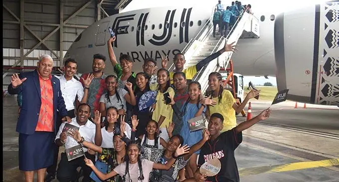 Prime Minister Voreqe Bainimarama with students at the Fiji Airways Airbus A350 Arrival Ceremony at the Nadi International Airport yesterday. Photo: WAISEA NASOKIA