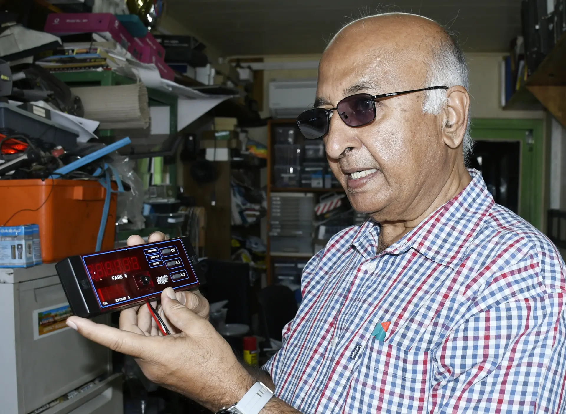 Safeway Electronics Director Tauz Khan explains the taxi meter calibration system as the newly approved temporary fare adjustments take effect from July 1, 2026.