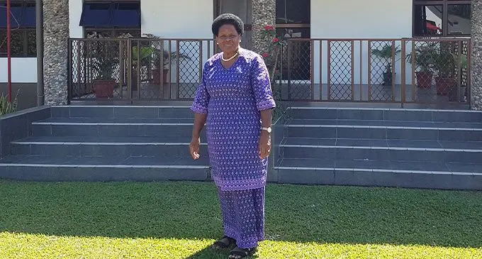 Lauwaki Village Chief, Adi Taina Rauvala standing in front of her home. Photo: Nicolette Chambers