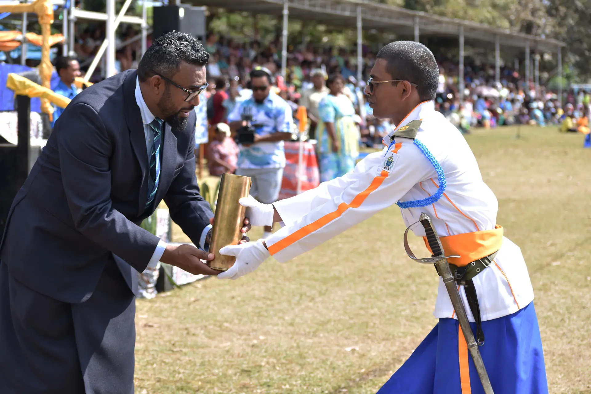 Natabua High School's Parade Commander and Head Boy Areeb Ali receives the most prestigious award of the 2026 cadet pass out parade, the Baton of Honour from TSLS CEO Dr Apisalome Mavono.