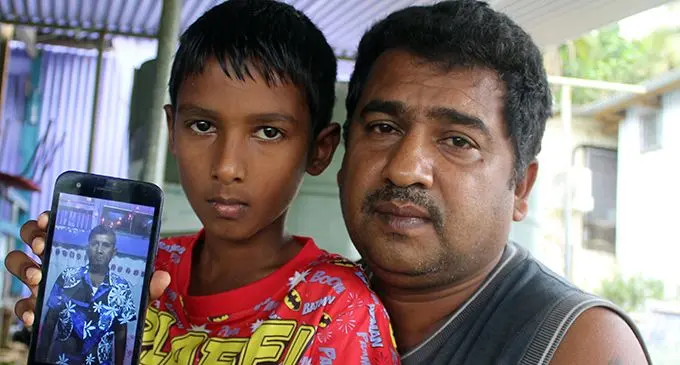 Arvind Sharma (right), with nephew Shavneel holding a picture of his late father, Umeshwar Prakash, at their Sawani home on August 11, 2019. Photo: Simione Haravanua
