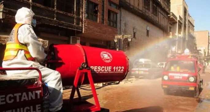 A worker sprays disinfectant on a road as a preventive measure against the spread of COVID-19 in Peshawar, Pakistan, on May 17, 2020.  (Photo by Saeed Ahmad/Xinhua)
