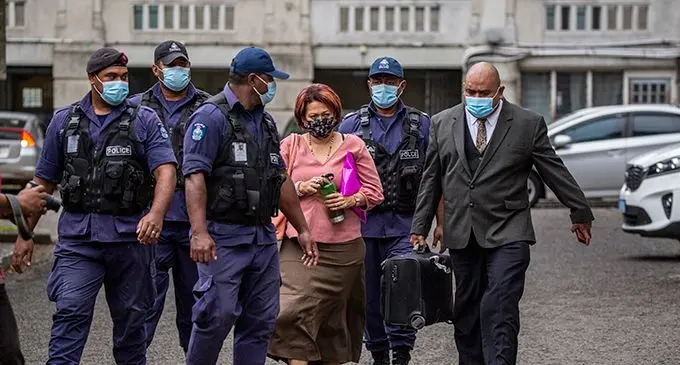 Veronica Malani is escorted by lawyer Simione Valenitabua and Police officers after her court case on September 10, 2021. Photo: Leon Lord