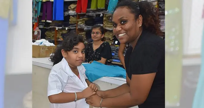 Michelle Tanishka assisted by her Aunt Faith Telma as she tries on her new uniform at Labasa Janta Store on December 10, 2019. Photo: Laisa Lui.
