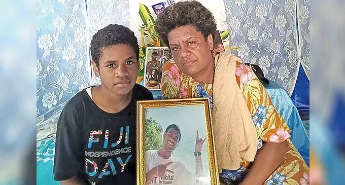 Matilda Baticavu and her mother Kelera Tawake with a photo of Eroni Tikoisuva at Nawajikuma, Nawaka, Nadi. Photo: Waisea Nasokia