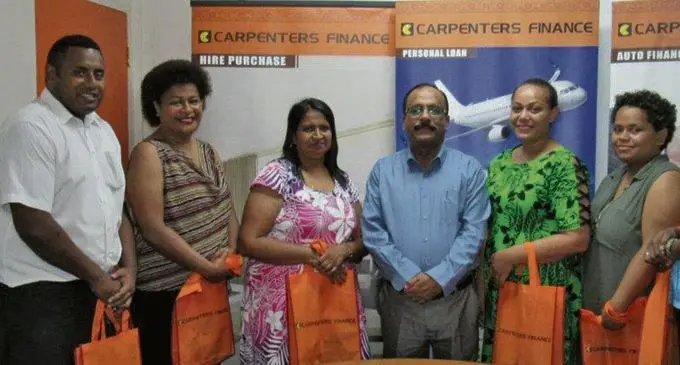 Director WR Carpenters (SP) Group and general manager Carpenters Finance Alok Mishra (centre) with the promotion winners. Photo: Carpenters Finance. 