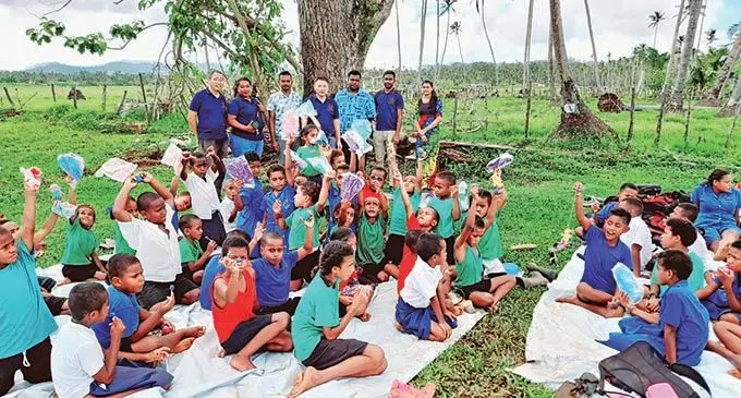 Director and Dean of the South Pacific Institute of Traditional Chinese Medicine, Dr Zhihui Tu, with Maramarua District School  students and management in Vanua Levu.