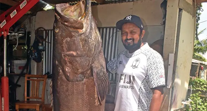 Fisherman Dineshwar Reddy with the huge Kawakawa fish at his home in Sonaisali, Nadi yesterday. Photo: WAISEA NASOKIA