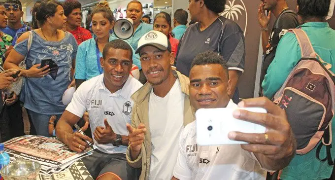 Fiji Airways 7s stars Aminiasi Tuimaba (left) and Jerry Tuwai taking a selfie with fan Semi Koroi at TappoCity in Suva on May 3, 2019. Photo: Simione Haravanua.