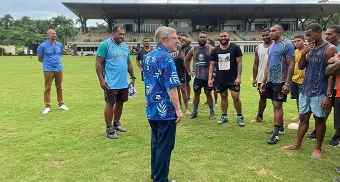 IOC president Thomas Bach with former Flying Fijians captain Ro Alifereti Doviverata and the Lakeba rugby team at Albert Park, Suva. Photo: FASANOC
