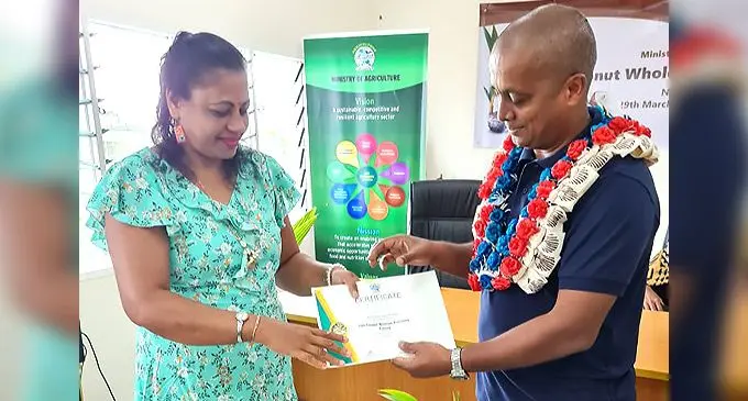 Ms Sulochna Wati Sharma of Vaqia, Ba receiving her certificate from PS Agriculture Vinesh Kumar.
