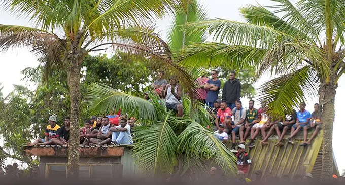 Rugby fans sit on the roof of a house beside Thomson Park in Navua to watch the Namosi’s clash against Naitasiri on August 8, 2020. Photo: Ronald Kumar