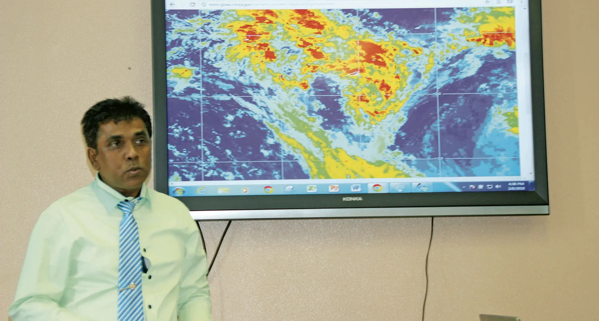 Director of Meteorology Ravind Kumar with the latest satellite images displayed in the background. Photo: Penioni Kuinikoro