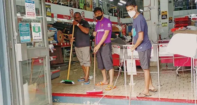 Vinod Patel Ba Branch staff ( left) Bishwa Pillay, Rakesh and Deepak Prasad clean up the inside of the store on January 11, 2022. Photo: Salote Qalubau