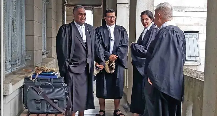 A photo of Solicitor General Ropate Green, lawyers Devanesh Sharma, Gul Fatima and Jon Apted, standing and speaking together outside the Civil High Court in Suva on June 15, 2023.