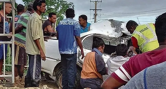 Community members remove the body of a 22-year-old man after the accident in Olosara, Sigatoka yesterday. 
