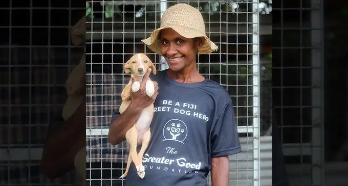 The Greater Good Foundation staff, Mereani Ranadi with a shelter dog.