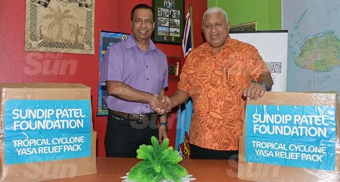 CJ Patel Group General Manager Sales and Distribution Pranil Singh and Prime Minister Voreqe Bainimarama during the hand over of the Sundip Patel Foundation relief packs to the Prime Minister’s National Disaster Relief & Rehabilitation: TC Yasa fund at the National Disaster Management Office (NDMO) in Suva on December 29, 2020. Photo: Ronald Kumar