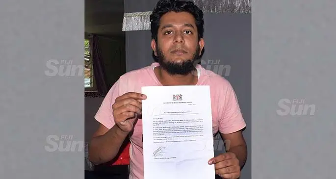 Mohammed Imroz with his COVID-19 clearance letter from the Ministry of Health at his Nabua home on May 22, 2020. Photo: Ronald Kumar