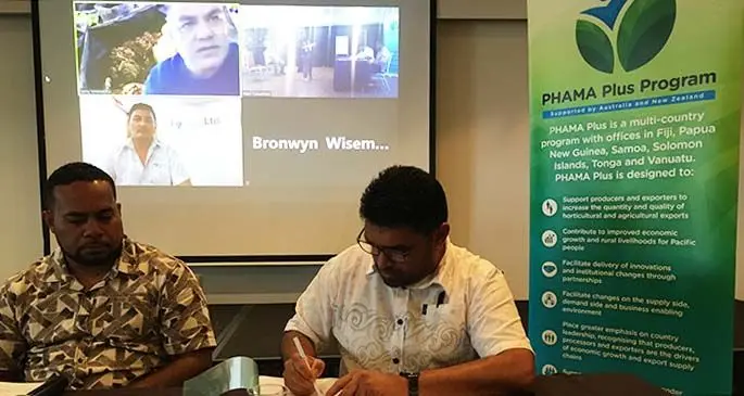 Pacific Horticultural and Agricultural Market Access Plus Programme national export market systems facilitator - Fiji Navi Tuivuniwai (left) in a signing ceremony with South Pacific Elixirs Limited operations manager Dharmendar Chand. Photo: Frederica Elbourne