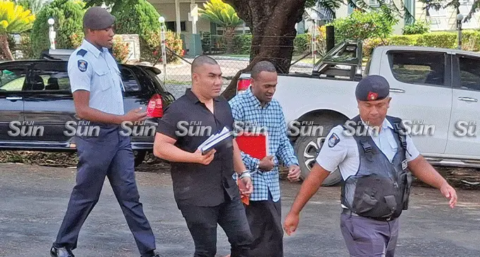 Accused Justin Ho and Viliame Colowaliku escorted by police officers to the High Court in Lautoka for trial on June 3, 2025. Photo: Mereleki Nai