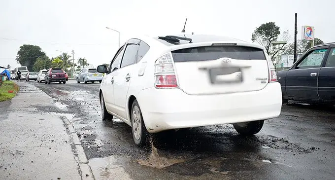 Drivers manoeuvre through potholes filled with water after the continuous downpour at Nakasi on April 22, 2019.  Photo: Ronald Kumar 