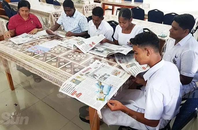 Tilak High School librarian Mrs P Singh, teacher N Ramlu with students Rahul, Berenadeta, Anush and Aryan all reading yesterday’s Fiji Sun newspaper as part of the Fiji Sun’s Newspapers in Education programme. Photo: Shonal Chand