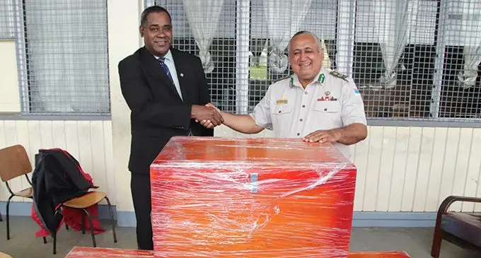 Fiji Corrections Service Commissioner Commander Francis Kean (right), hands over the wooden chests to Ratu Kadavulevu School vice principal Sakiusa Kuruduadua. 