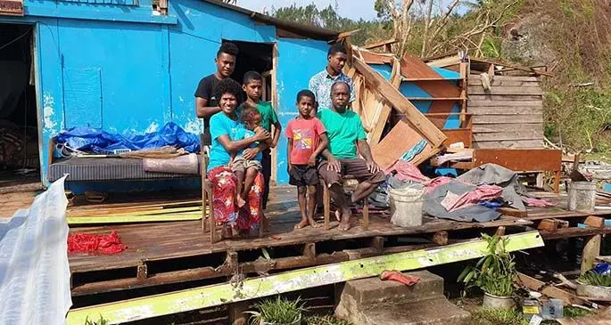 Alanieta Veronika with her husband Lasarusa Wainimala and their children in front of their house that was damaged by Tropical Cyclone Harold in Naqara Village in Ono, Kadavu. Photo: Supplied