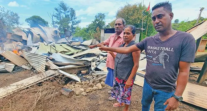 From left, Jaswant Prasad, Nirmala Wati and their son Sanjay Prasad at the remains of their home after it was destroyed by fire at Lajonia, Labasa on November 29, 2024. Photo: Sampras Anand