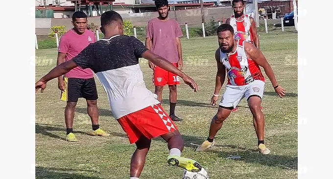 Labasa football defender Sitiveni Rakai passes the ball past Ilisoni Logaivau during their training session in Labasa last week. Photo: Sampras Anand.