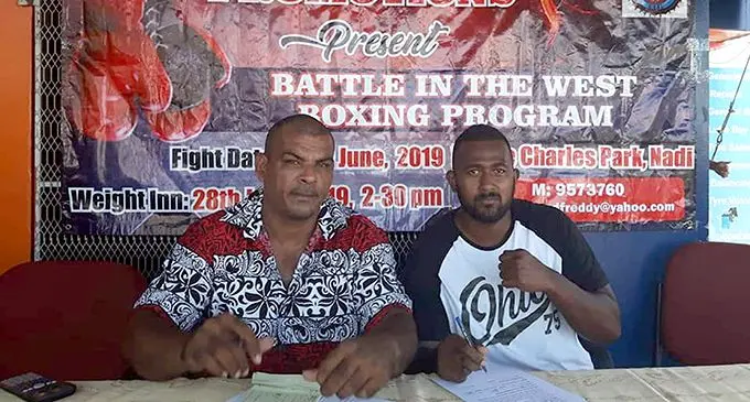From left: South Pacific Boxing Promotions promoter Freddy Chand with heavyweight boxer James Singh signing his contract for the Petero Qica fight at Martintar, Nadi on May 1, 2019. Photo: Supplied by SPBP
