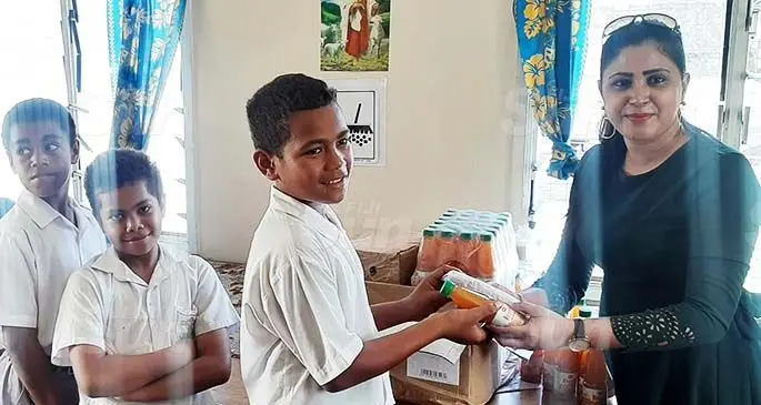 Circle of Friends member Naazrin Nisha distributes lunch packs to students of Saint Thomas Primary School in Lautoka on August 25, 2020. Photo: Salote Qalubau