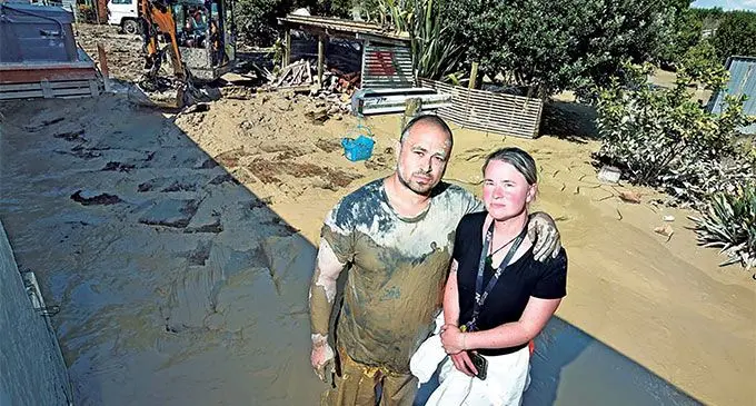 Gisbourne, New Zealand couple Tu Ben and Sarah Aperahama infront of their compound after the recent floods in New Zealand. Photo: RNZ Pacific