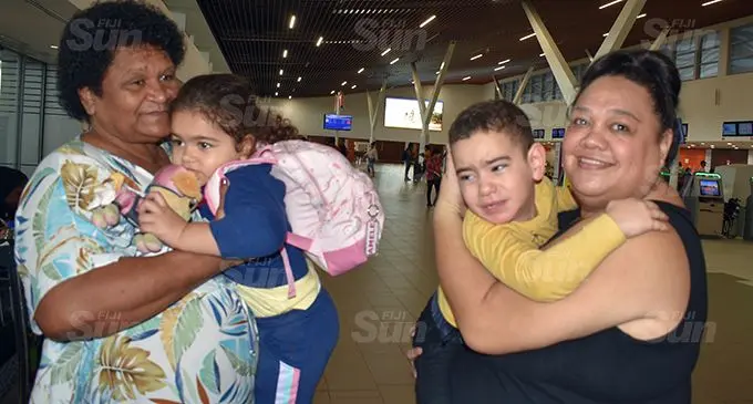 Grandmother Asinate Ravouvou (left) holding Amele Ravouvou and Renee Nanukubalavu holding Vatemo Ravouvou at the Nadi  International Airport.  Photo: Mereleki Nai