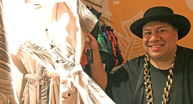 Samson Lee shows a piece from his collection during the re-opening of the SL boutique in Suva, on April 28, 2022
