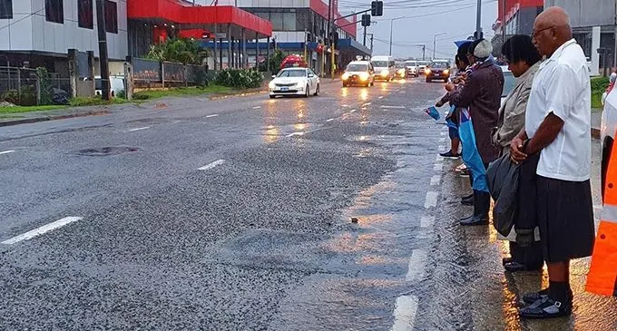 Opposition leader and caretaker SODELPA leader Sitiveni Rabuka, with wife, Suluweti, farewell former Prime Minister Laisenia Qarase as his funeral cortège travels along the Kings Road on Ratu Mara Road in Nabua yesterday on its way to the Nausori International Airport bound for Vanuabalavu.