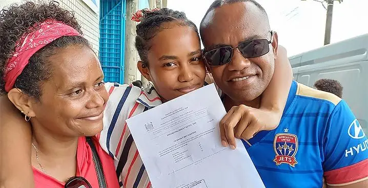 Proud parents Atunaisa and Akisi Ratuvuwai hug their daughter, Kelera Ratuvuwai of Namosi Secondary School in Suva on January 31, 2023. Photo: Ronald Kumar