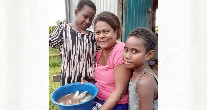 Siteri Tonga with her two children Luisa Cawai 8 and Ulamila Waiwaidina 7 at their Wainividio settlement home in Navua. Photo: Ronald Kumar