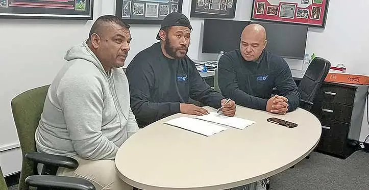 From left : South Pacific Boxing Promotions promoter Freddy Chand, heavyweight boxer Puna Rasaubale signing the contract with Kaiviti Silktails CEO Stephen Driscoll looking on in Sydney, Australia. Photo: Supplied