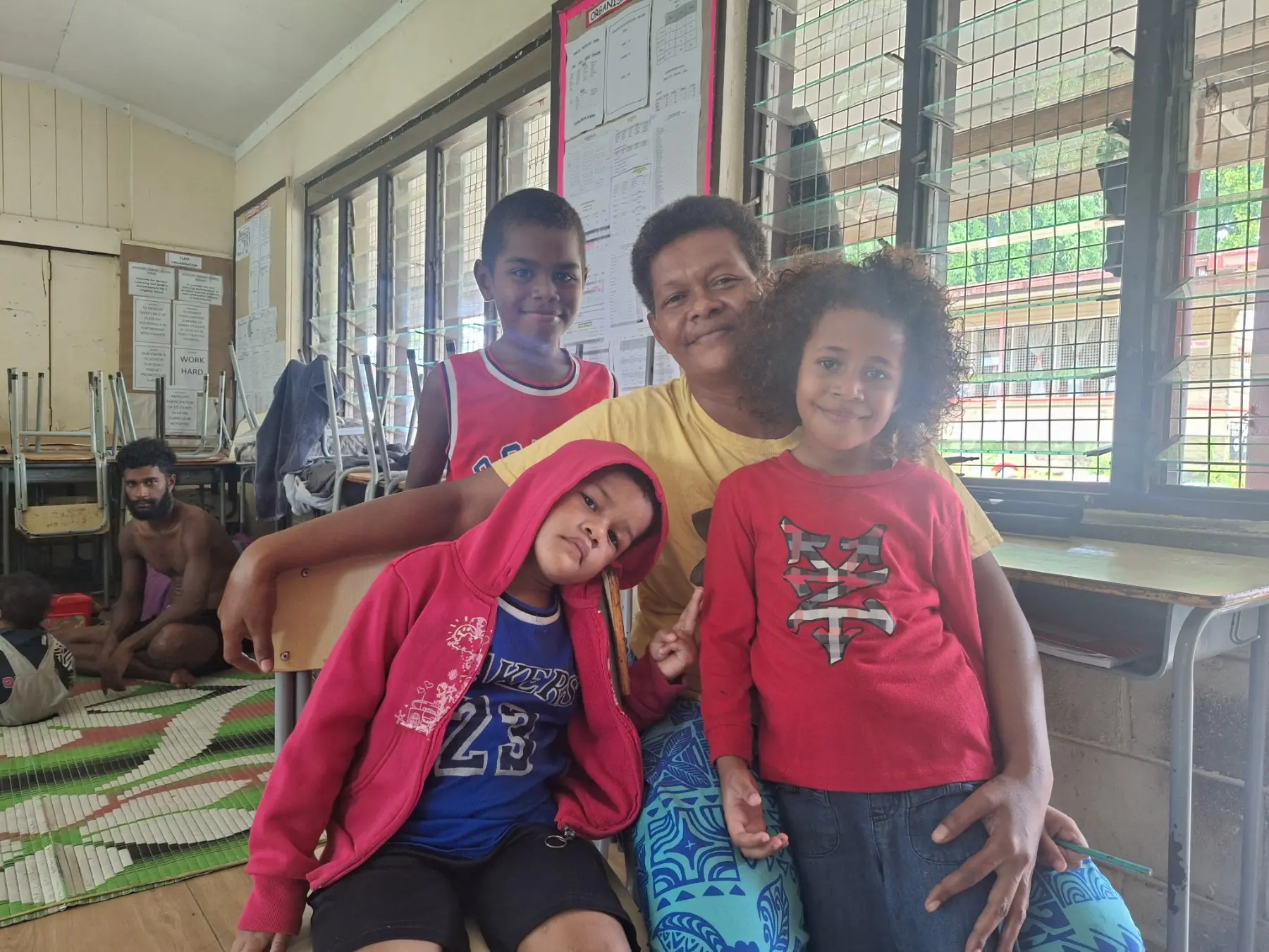 Luisa Kaira of Nawajikuma settlement with her family at the evacuation centre at Andrews Primary School in Nadi. 