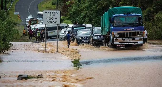 Drivers had to cross this flooded road on December 18, 2023, outside Galea Village with caution following 24 hours of heavy rain. Photo: Leon Lord